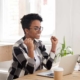 black woman rejoicing with her hands in the air at her computer from a low hanging fruit quick win in SEO.